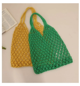 Detailed knit texture of yellow and green cotton rope beach bags with cutout mesh patterns