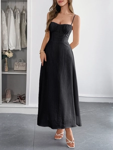 Close-up of black bodycon maxi dress featuring ruched fabric and a strapless neckline