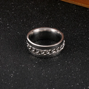Cool stainless steel spinner ring with rotatable chain inlay on dark textured background