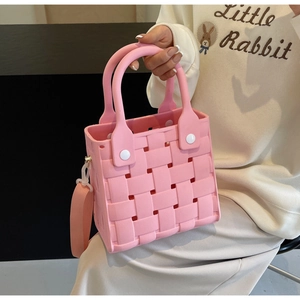 Detailed view of pink EVA woven tote bag with hollow design and matching handle