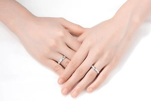 Close-up of minimalist silver crown rings with zircon on model's hands in high detail