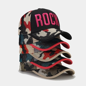 Stack of camouflage baseball caps with ROCK embroidery and pink letters for outdoor sport