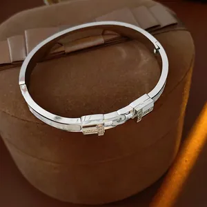 Minimalist silver titanium steel T-shaped bangle with inlaid zircon on jewelry box