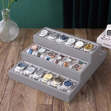 Présentoir de montres gris à trois niveaux pour vitrines de luxe