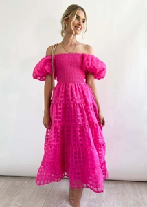 Detail showing the textured pink checkered fabric and elastic smocked bodice
