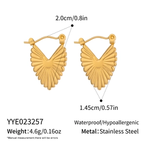 Detailed view of heart-shaped gold fan earrings with textured stainless steel surface