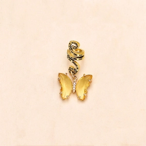 Detail of a golden butterfly hair ring with yellow crystal wings and sparkling rhinestones
