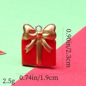 Macro view of a red gift box pendant with gold bow showing dimensions and weight