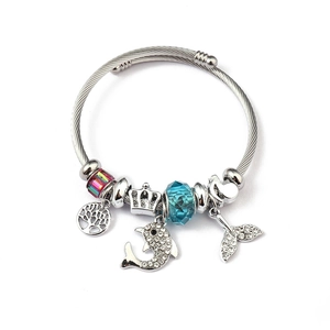 Detail of ocean-themed charm bracelet with dolphin, tree of life, and crystal beads