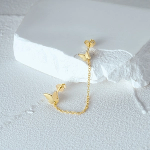 Detailed view of gold S925 sterling silver butterfly stud earrings with a delicate connecting chain