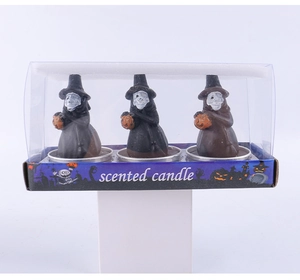 Three spooky Halloween ghost candles in black and brown cloaks with pumpkins in clear box