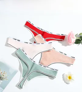 Flat lay of four ribbed cotton thongs with LOVE YOU printed waistbands and white trim