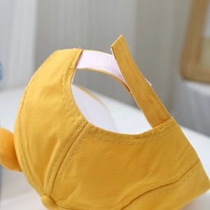 Detail of adjustable velcro strap on yellow cotton baby baseball hat for custom fitting