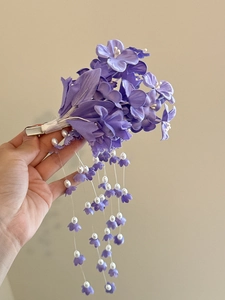 Detail of purple lily of the valley tassel hair clip with silk flowers and pearls