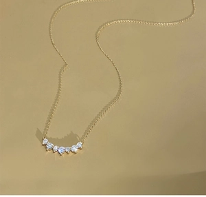 Macro view of five sparkling cubic zirconia stones on an 18K gold plated silver chain