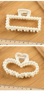 Detail view of large pearl hair claw clips in rectangular and heart shapes with ruler