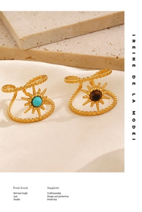 Detailed shot of gold-plated starburst rings with turquoise and tiger eye stones