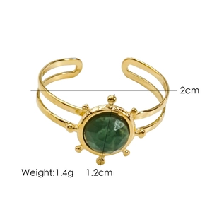 Detailed view of gold open bangle with 1.2cm green gemstone and 2cm inner diameter