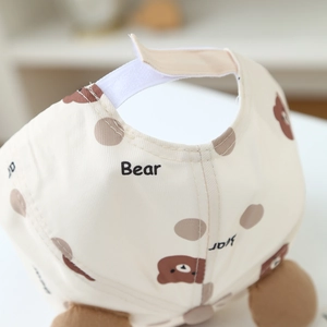 Close-up of adjustable velcro strap and bear print on cotton baby baseball cap