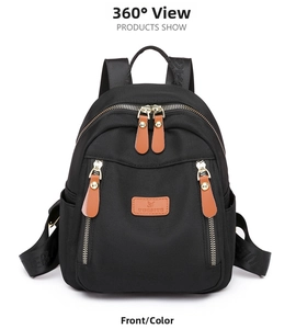 Close-up of black nylon backpack featuring brown leather zipper pulls and logo detail