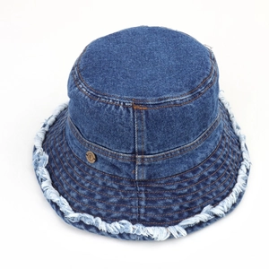 Detailed view of dark blue denim bucket hat with frayed edges and small metal buckle