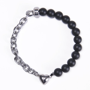Detail of magnetic heart clasp connecting silver metal chain and black matte beads