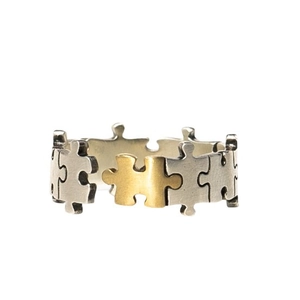 Thai silver puzzle ring with gold puzzle piece accent in minimalist open design