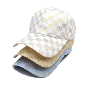 Checkered baseball hats in white, blue, and beige with metallic foil print texture