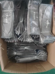 Detail view of cartoon shark mesh storage bags packed in bulk inside a cardboard box