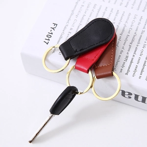 Creative PU leather and metal magnetic keychains in black, red and brown on book