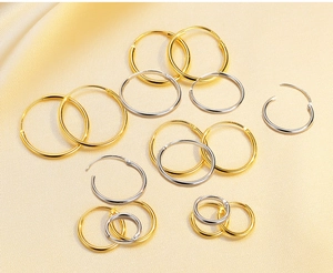 Detailed view of gold and silver S925 sterling silver hoop earrings in various sizes