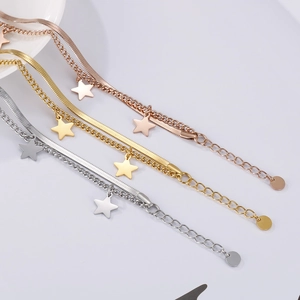 Detailed view of double-layer star charm bracelets in gold, silver, and rose gold finishes