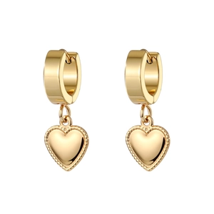 Detail of gold heart earrings with milgrain edges and polished huggie hoop closure