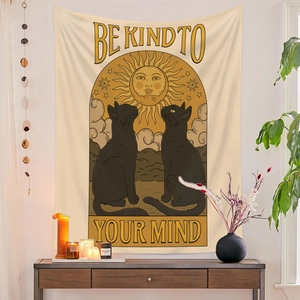Detail of wall tapestry featuring black cats, sun and Be Kind To Your Mind text