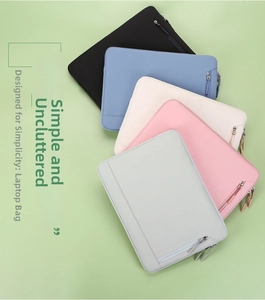 Flat lay of minimalist laptop sleeve cases in black, blue, beige, pink, and grey colors