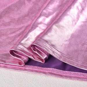 Détail du tissu rose métallisé avec doublure violette et finitions de couture précises