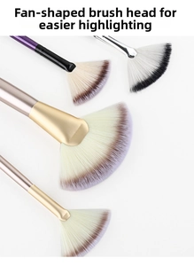 Close-up of professional fan brushes with soft gradient bristles and metallic handles