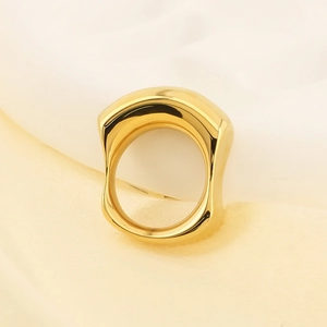 Macro shot of 18k gold plated stainless steel ring with polished irregular square design