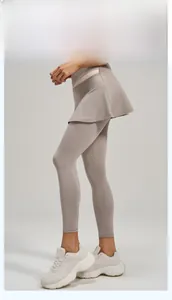 Detail of high waisted fake two-piece yoga leggings with skirt in light grey breathable fabric