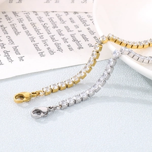 Close-up of gold and silver tennis bracelets with square zircons on an open book