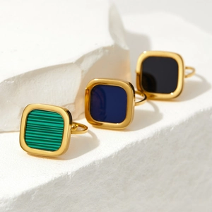 Square minimalist gold rings with malachite green, deep blue, and black inlays on stone