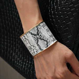 Detail of vintage wide leopard print leather cuff bracelet with gold metal edges
