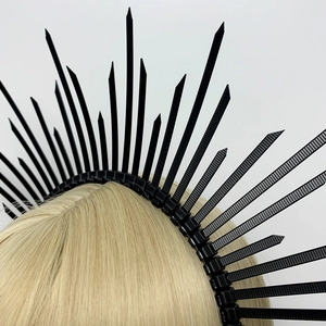 Detail shot of a black spiked halo headband crown for cosplay on blonde hair