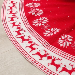 Knitted 120cm Christmas tree skirt with reindeer and snowflake patterns on wood floor