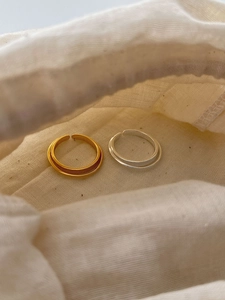 Close-up of adjustable S925 sterling silver rings in gold and silver matte finishes