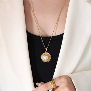 French vintage style gold straw hat pendant necklace with pearl on elegant female model