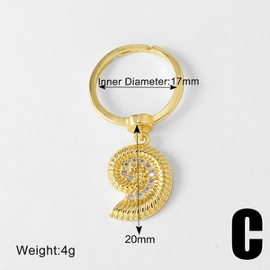 Detail view of gold ring with conch shell pendant featuring crystals and 17mm inner diameter