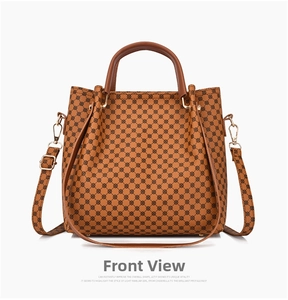 Front view of a brown vintage tote bag featuring a dense dot pattern and golden buckles