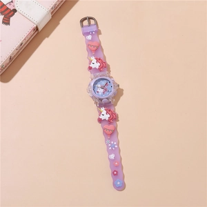 Detail of purple silicone strap with 3D unicorn and glowing dial on children's watch
