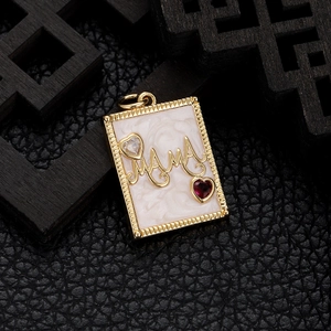 Macro detail of gold MAMA rectangular pendant with red and clear heart-shaped crystals